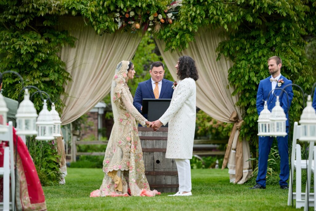 Indian wedding dress in front of arbor